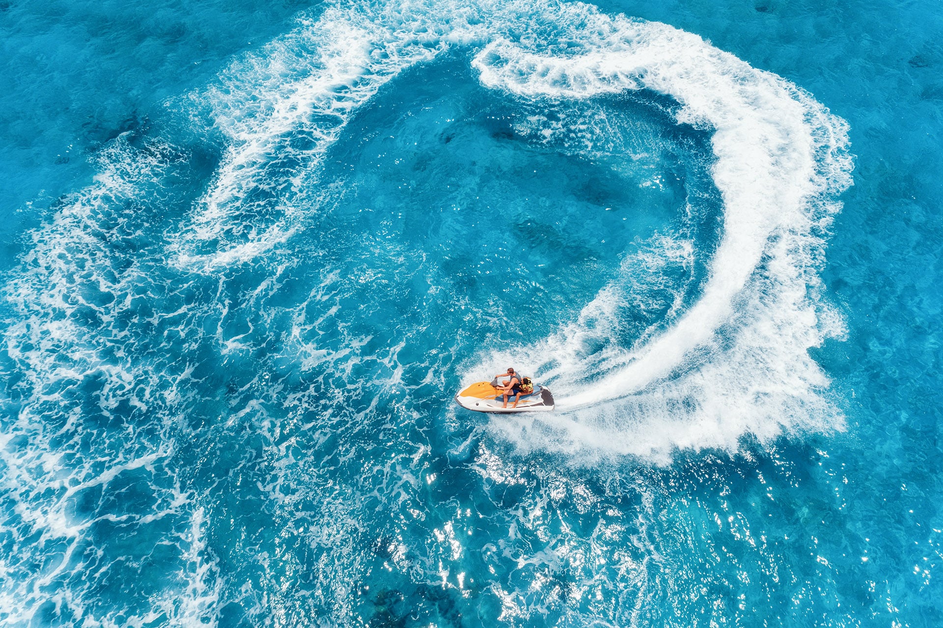 aerial-view-of-floating-water-scooter-in-blue-wate-2023-11-27-05-27-36-utc-min